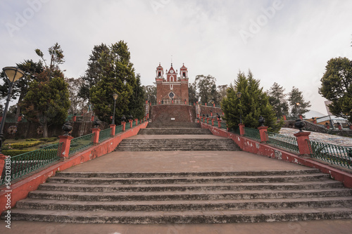 Facade of the Calvario church in Metepec, State of Mexico, built with volcanic stone and painted red. photo