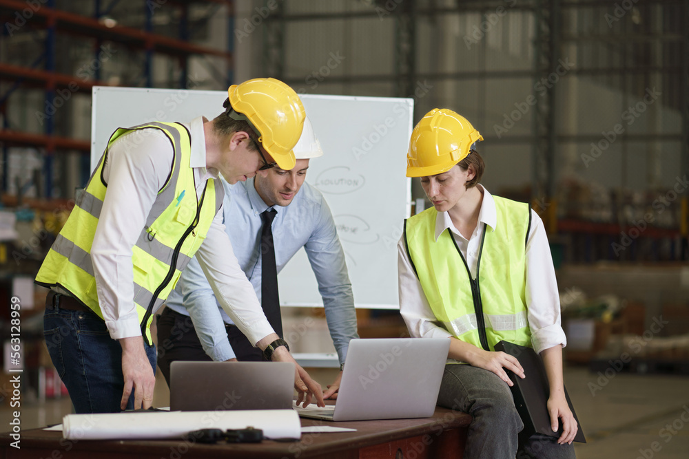 Caucasian engineers, architect, industrial worker have meeting, with laptop and blueprint on the table inside the factory, concept teamwork, construction worker, industrial occupation. Caucasian engineers, architect, industrial worker have meeting, with laptop and blueprint on the table inside the factory, concept teamwork, construction worker, industrial occupation.