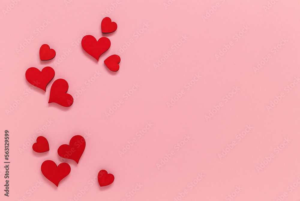 Red wooden hearts on a pink background. Valentine Day concept. Top view. Copy space.