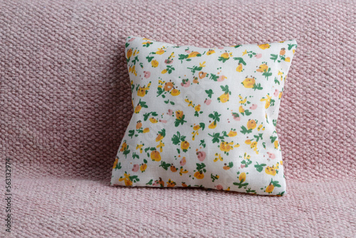 Soft,floral pattern cushion on pink sofa