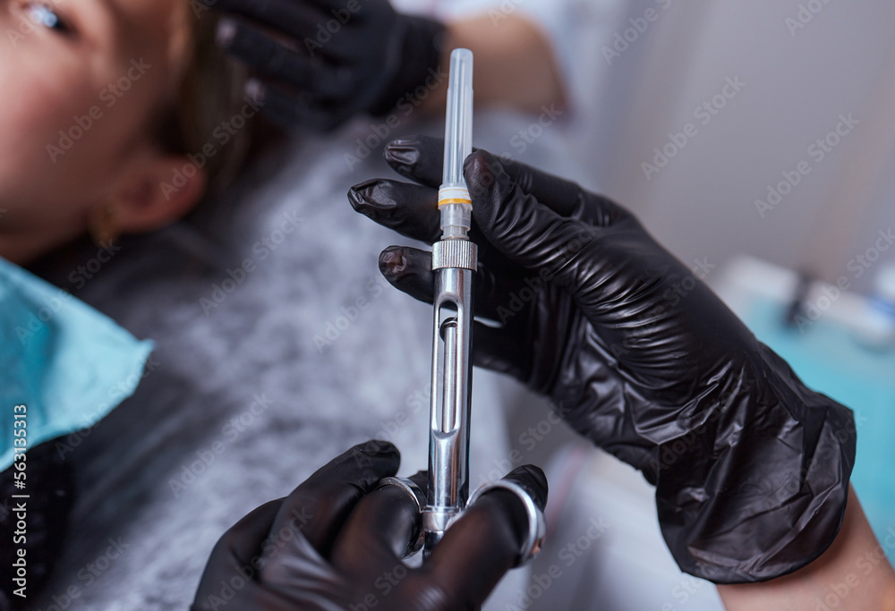 Little girl at dentist office, getting local anesthesia injection into