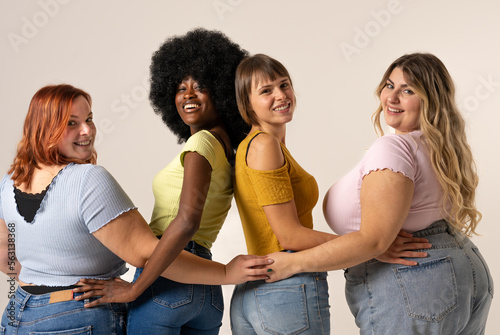 Papier peint Four diverse and confident women of different nationalities and body types smiling the camera and  radiating positivity