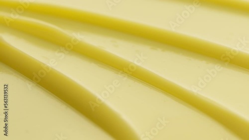 Macro shot of yellow anti-wrinkle cream with gingseng extract furrow texture with a reflection of light on it | Anti-wrinkle cream background shot for its commercial photo