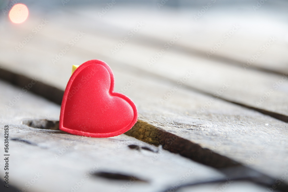 Fototapeta premium Red heart on a wooden background. Place for text. Valentine.