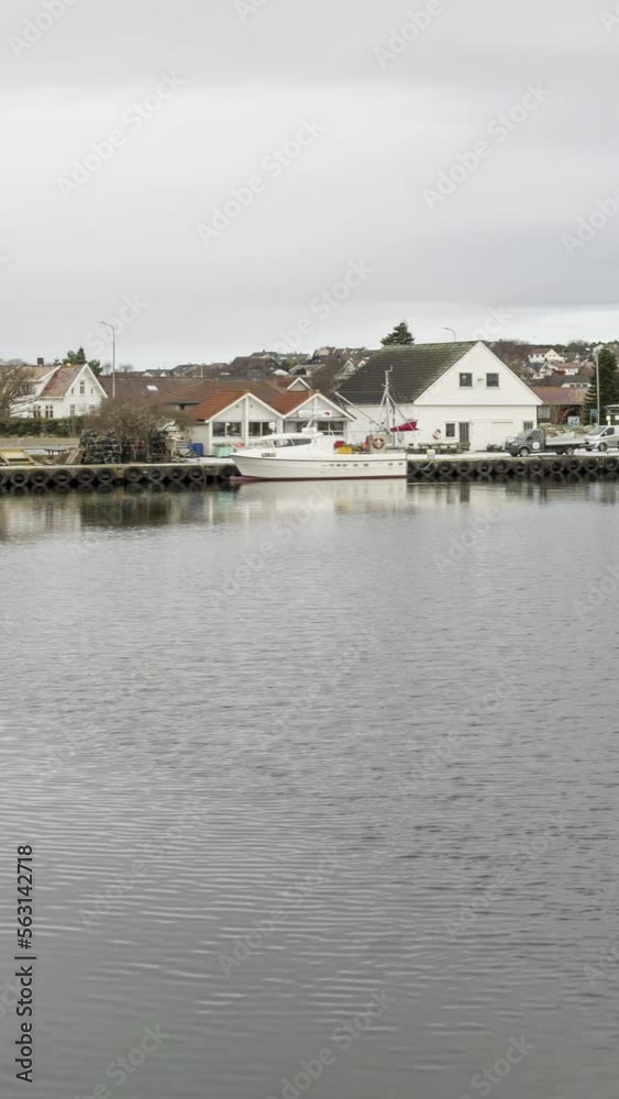 Vertical Timelapse of a small marina with boats on the coast of western Norway Vertical Timelapse of a small marina with boats on the coast of western Norway