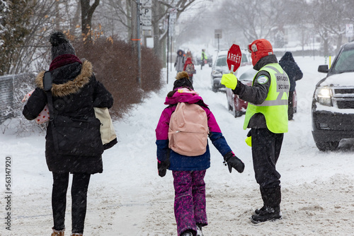 Brigadier scolaire faisant son travail pendant une averse de neige photo