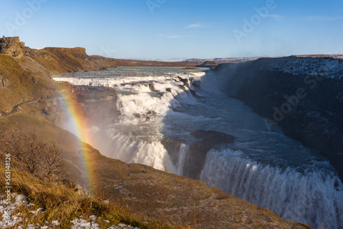 Gullfoss waterfall in Hvítá river canyon in southwest Iceland. Popular falls on the Golden Circle tourism route. Rainbow in the mist from two stage cascade. 