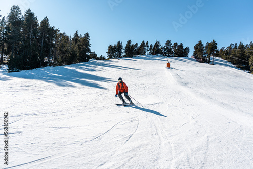 A boy skiing down a large ski slope.