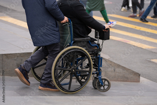 The guy carries a man in a wheelchair © Daniel