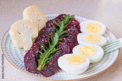 Breakfast, dinner, lunch is prepared from boiled beets, arugula, broccoli and boiled eggs