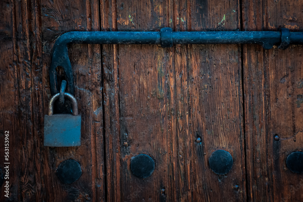 Old rusty lock hook and padlock on wooden door. Old rustic wooden door with padlock vintage concept Old rusty lock hook and padlock on wooden door. Old rustic wooden door with padlock vintage concept