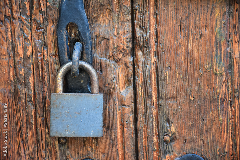 Old rusty lock hook and padlock on wooden door. Old rustic wooden door with padlock vintage concept Old rusty lock hook and padlock on wooden door. Old rustic wooden door with padlock vintage concept
