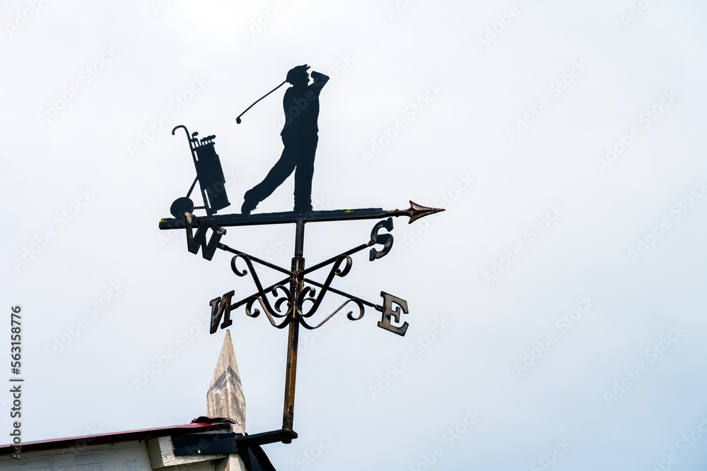 Silhouette of a weathervane representing a golfer, close up