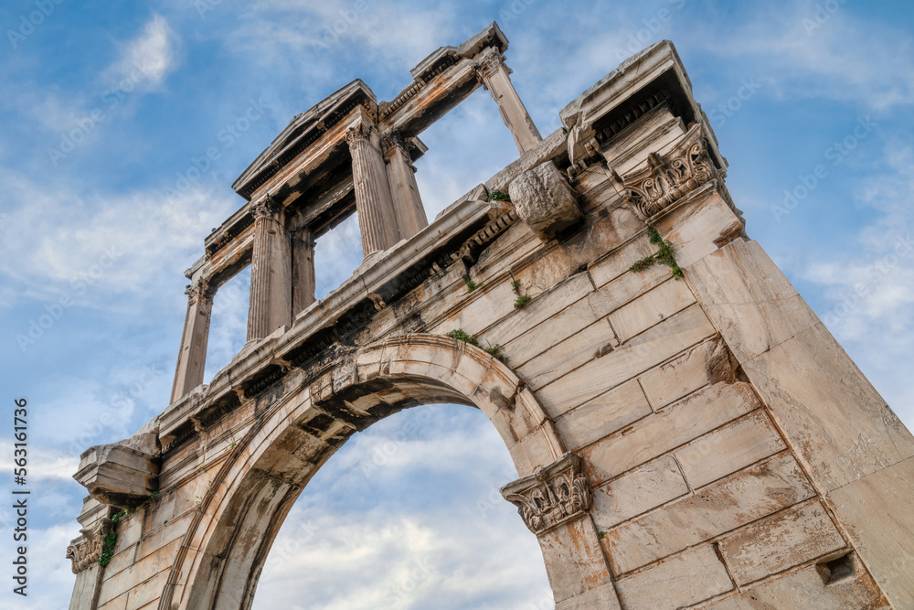 Athens, Attica, Greece. The Arch of Hadrian, most commonly known in Greek as Hadrian's Gate, is a monumental gateway resembling, in some respects, a Roman triumphal arch.  Low angled view, cloudy sky