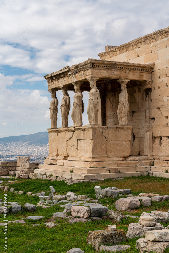 The Caryatids of Erechtheion Temple (Erechtheum) at the archaeological site of Acropolis. Caryatids are sculpted female figures used as decorative architectural support, daytime, cloudy sky