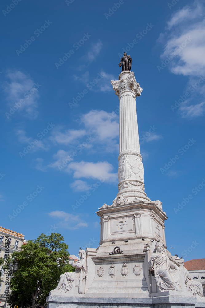 A huge white stone column with a bronze statue of a king of Portugal Pedro IV at the top, Rossio Square, Lisbon, Portugal