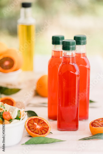 various salad vinegars in glass bottles. Front and top view. apple, lemon, strawberry, quince, grape, melon, apricot, tangerine, orange, grapefruit,