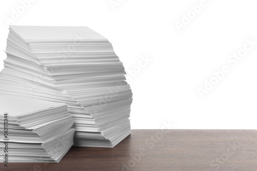 Stacks of paper sheets on wooden table against white background. Space for text