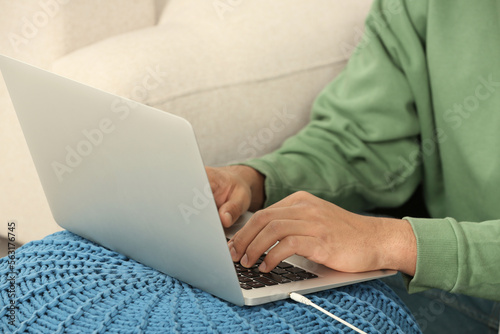 African American man typing on laptop indoors, closeup