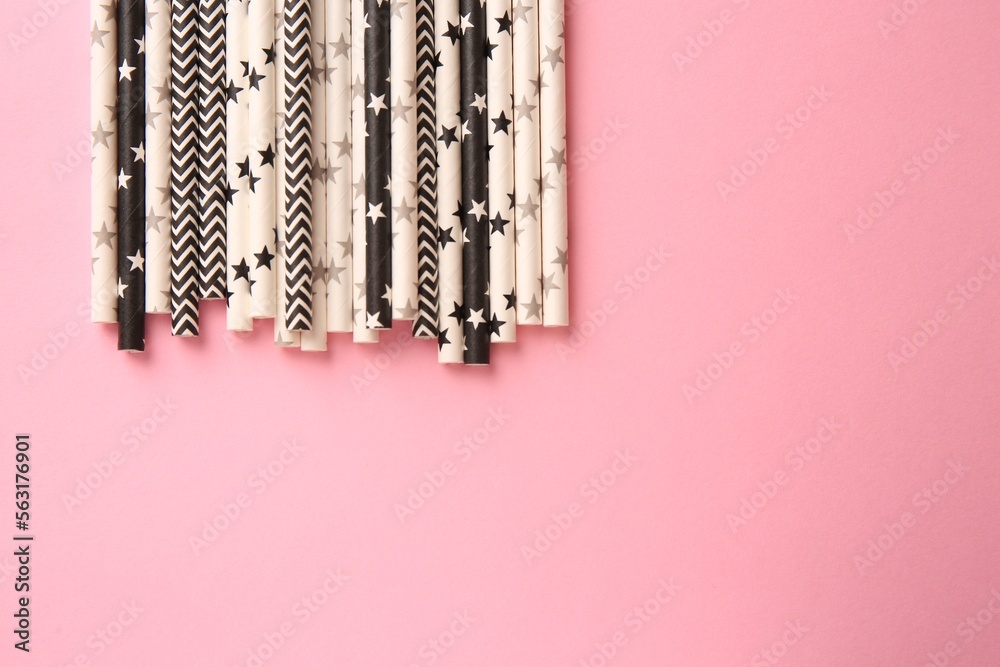 Many paper drinking straws on pink background, flat lay. Space for tex