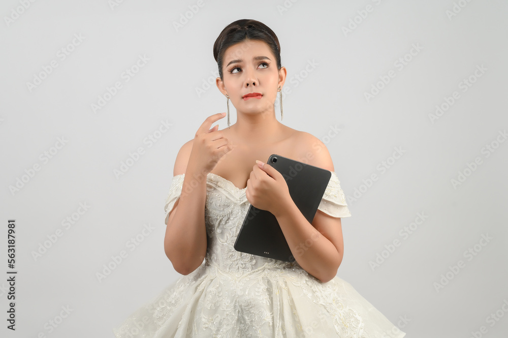 Young asian beautiful bride pose with tablet in hand Young asian beautiful bride pose with tablet in hand