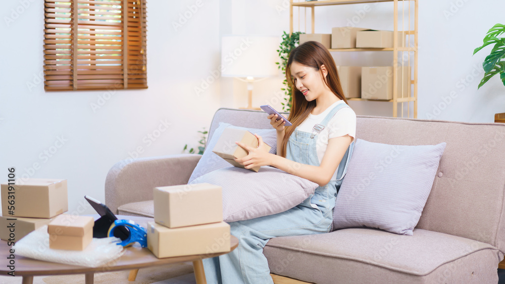 Online merchant concept, Female entrepreneur use smartphone to take picture parcel boxes to client Online merchant concept, Female entrepreneur use smartphone to take picture parcel boxes to client