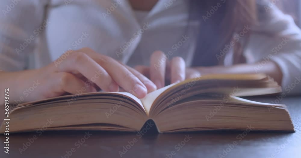 Close up hand and finger of woman reading and open book page for education on table.Learning by yourself with knowledge textbook.Lifestyle of people relax reading magazine in library on holiday. Close up hand and finger of woman reading and open book page for education on table.Learning by yourself with knowledge textbook.Lifestyle of people relax reading magazine in library on holiday.