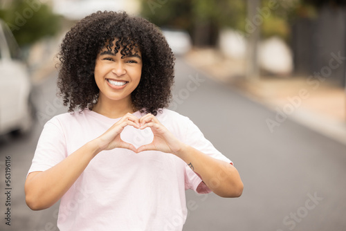 Heart hands sign, black woman and portrait of a young person in a urban street showing love gesture. African female, happiness and smile with mock up space with hand making emoji shape outdoor © Alexis S/peopleimages.com