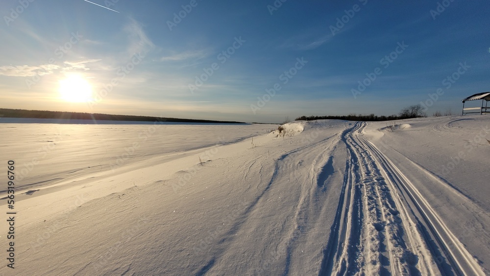 Beautiful winter landscape. Snow covered river and road