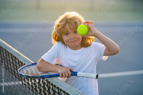 Tennis. Child boy tennis beginner playing tennis on court.