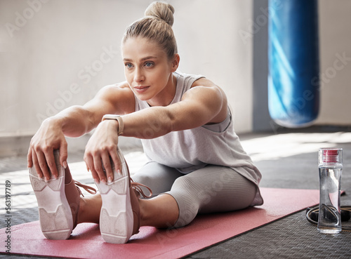 Yoga, woman stretching and pilates of a young female athlete in a fitness gym for exercise. Workout, zen and sport workout of a person with peace and leg stretch for wellness and sports health