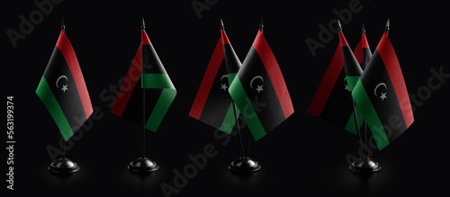 Small national flags of the Libya on a black background