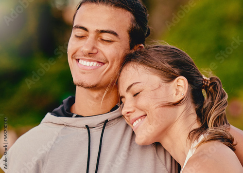 Happy couple, smile and hug embracing relationship and spending quality time together in the outdoors. Man and woman relaxing and smiling for holiday break, fresh air and satisfaction in nature