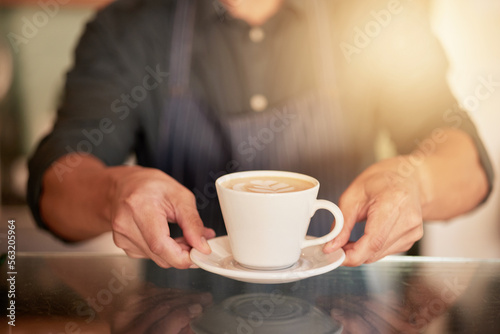 Coffee  cafe and hands of waiter with cup on table in restaurant. Small business  cappuccino art or barista  man or server holding fresh  delicious or hot mug of caffeine or espresso in shop or store