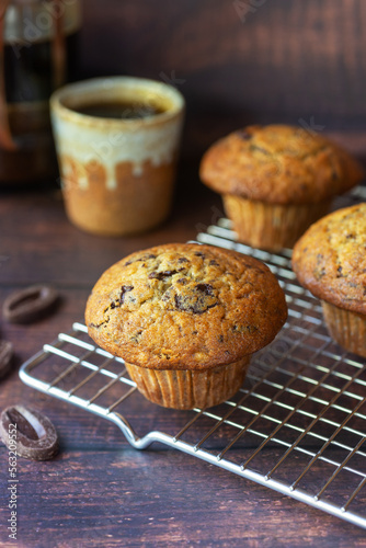 freshly baked homemade banana chocolate muffins on wooden table background.