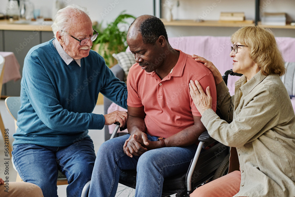 Obraz premium Senior people supporting their friend with disability while he worried about his disease