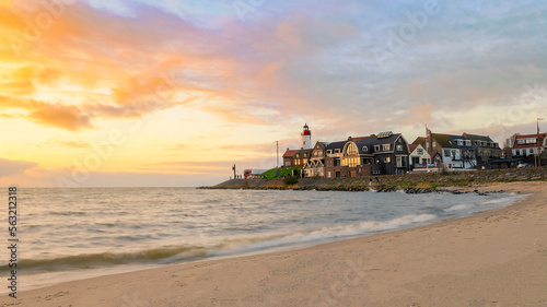 Urk Flevoland Netherlands sunset at the lighthouse and harbor of Urk Holland. Traditional Fishing village Urk. Beautiful sunset during the evening photo