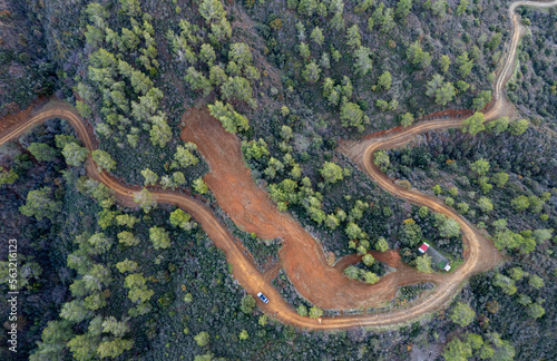 Drone aerial of rural curved road passing through the mountain. Discovery and adventure in nature photo