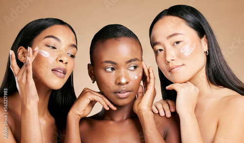 Face cream, skincare and women in studio for wellness, grooming and hygiene against brown background. Friends, beauty and lotion for girl group with different, facial and skin product while isolated