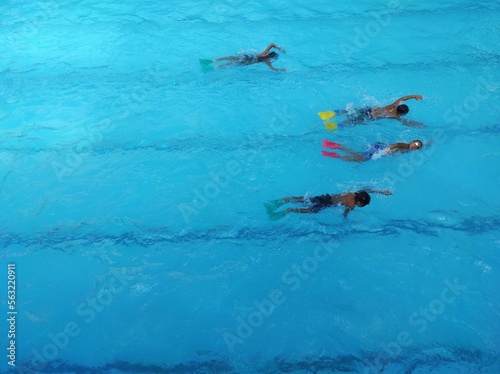 High angle view of Children practice swimming in the pool