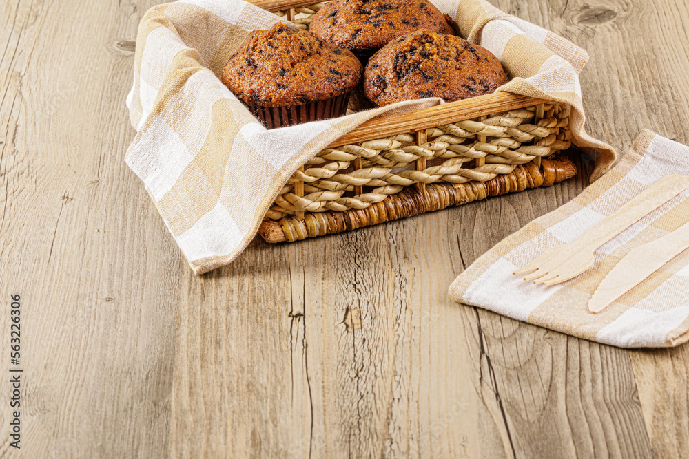 Homemade Banana Choco Muffins on a wooden table Homemade Banana Choco Muffins on a wooden table