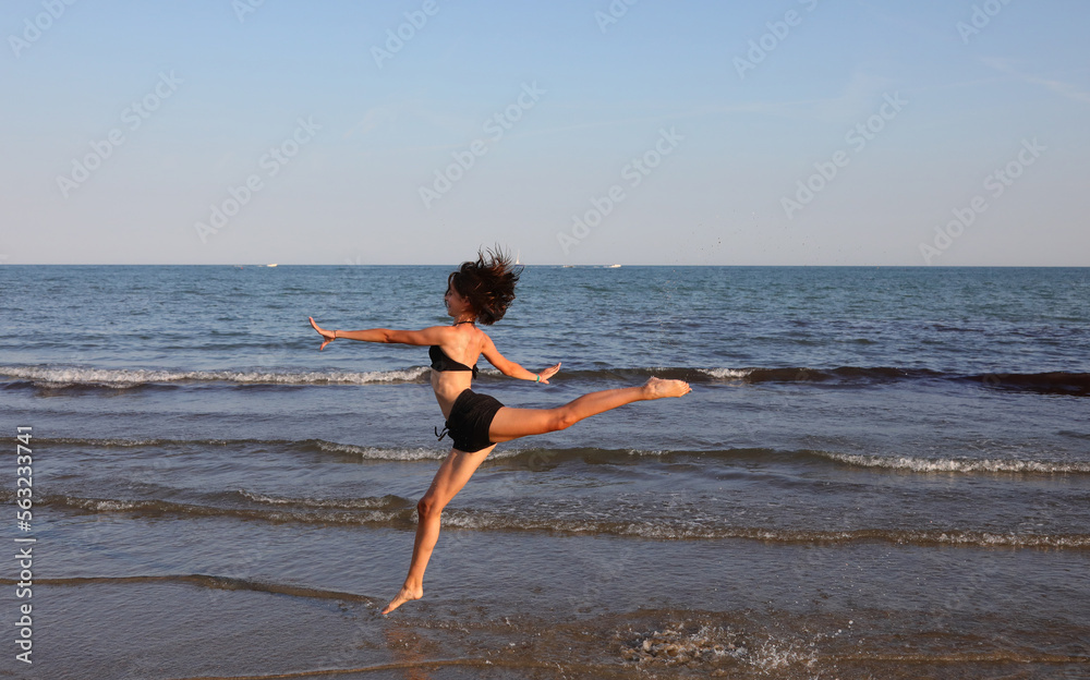 young slim athletic girl performs gymnastic exercises in summer young slim athletic girl performs gymnastic exercises in summer