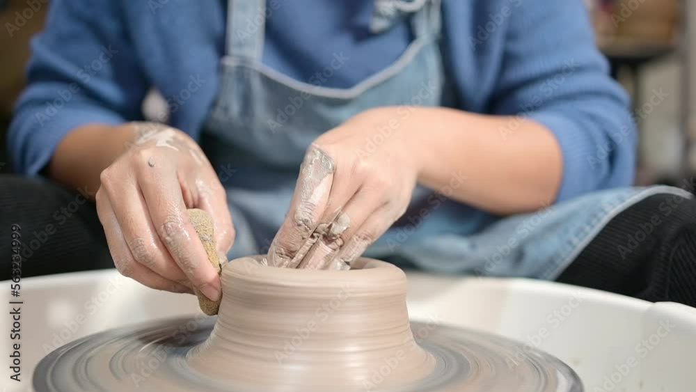 Pottery artist, Young female making a piece of clay molding calmly and meticulously In order to produce the most attractive work possible, Pottery artist, Young female making a piece of clay molding calmly and meticulously In order to produce the most attractive work possible,