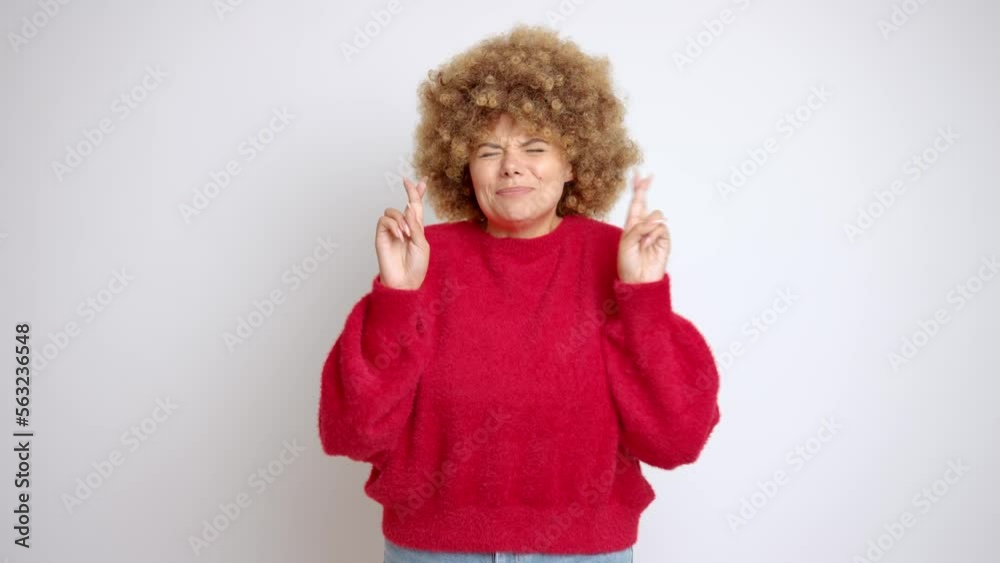 Woman making a wish, gesturing with both hands up, finger cross, close her eyes dreaming, isolated Woman making a wish, gesturing with both hands up, finger cross, close her eyes dreaming, isolated