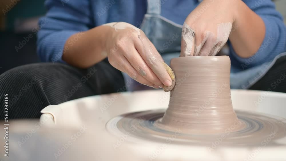 Pottery artist, Young female making a piece of clay molding calmly and meticulously In order to produce the most attractive work possible, Pottery artist, Young female making a piece of clay molding calmly and meticulously In order to produce the most attractive work possible,