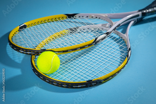 Tennis ball and rackets on the blue background.