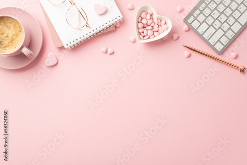 Valentine's Day concept. Top view photo of planner keyboard stylish glasses pen heart shaped saucer with sprinkles and cup of coffee on isolated pastel pink background with copyspace