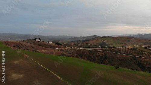4K sunset drone footage over beautiful houses, fields and mountains at Abdalajis valley, Antequera, Malaga, Spain.
Mid angle, parallax movement.