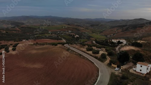 4K sunset drone footage over cars driving through road with fields and mountains on the back at Torcal mountain, Antequera, Malaga, Spain.
Mid angle, panoramic movement.