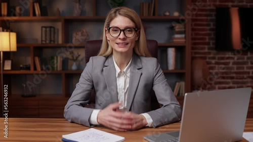 Friendly business woman talking at webcam making conference video call for job interview, business coach looking at camera recording vlog webinar, online training, e-coaching, consulting client online